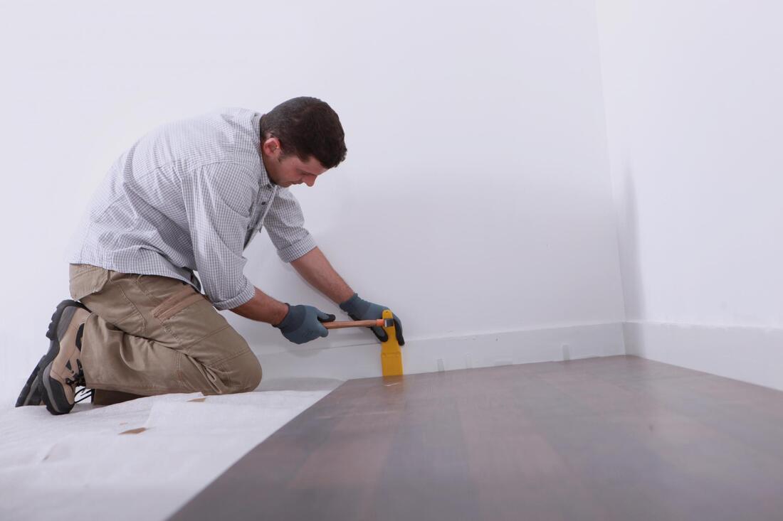 man finishing a flooring
