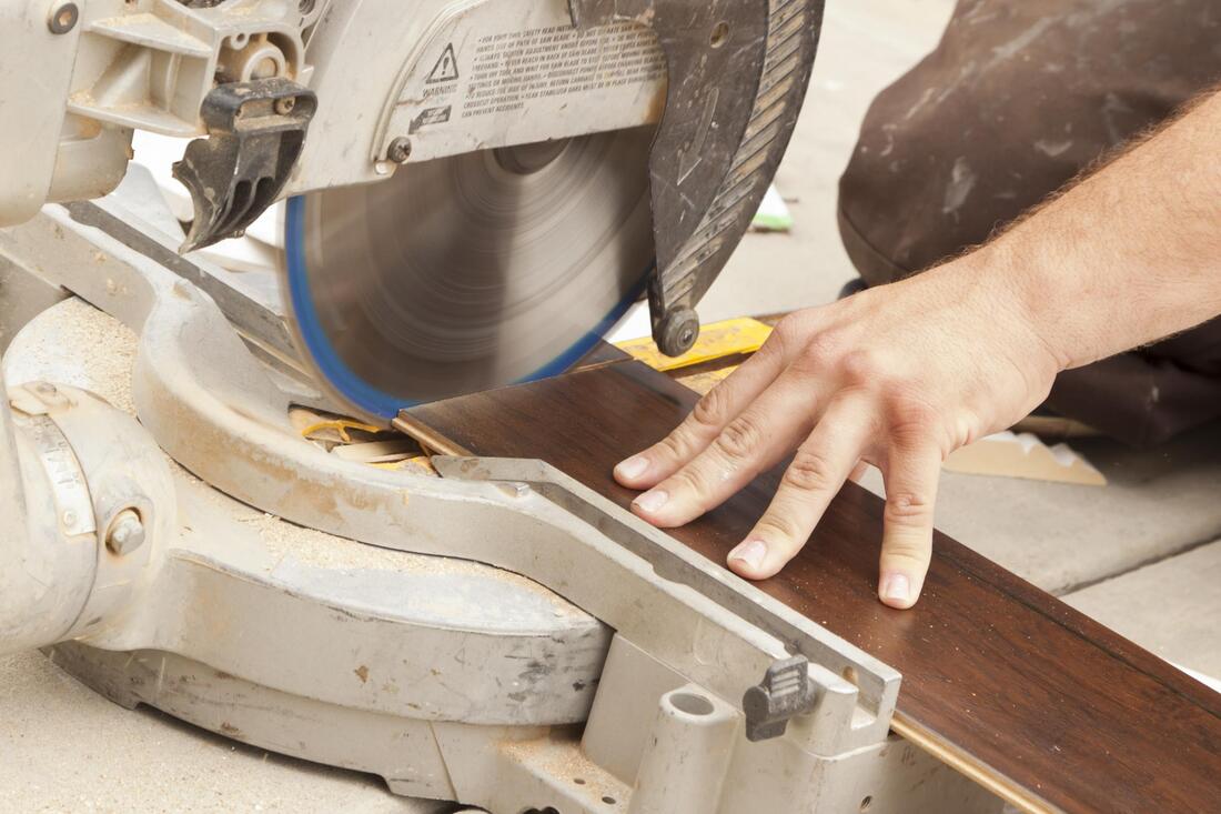 man cutting a hardwood flooring